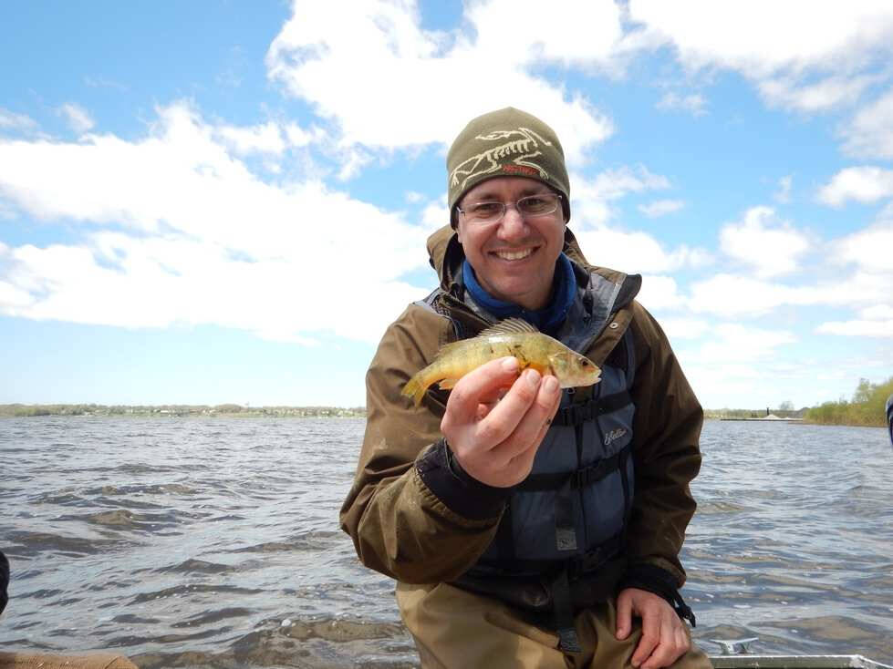 Dr. Carl Ruetz displays a fish for the camera.